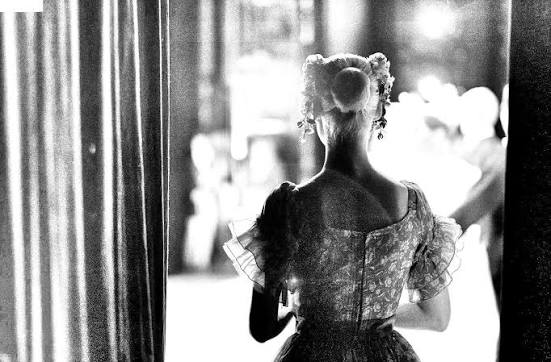 Performer waiting backstage before stepping into the light